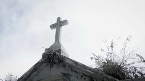 Low Angle of a Marble Cross on a Crypt in a Graveyard in 4k Stock Footage 90018060