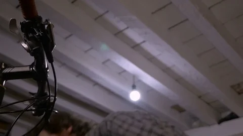 Low angle of a mechanic bleeding disc brakes on a bicycle Stock Footage 69908523