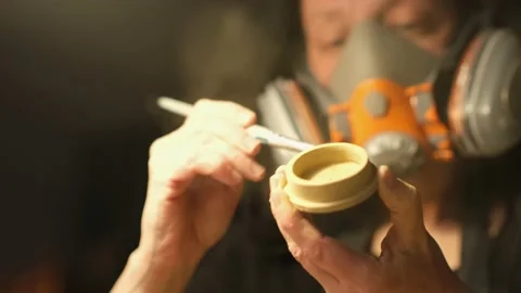 Low angle medium close up of female ceramist sanding ceramic cap Stock Footage 236329058