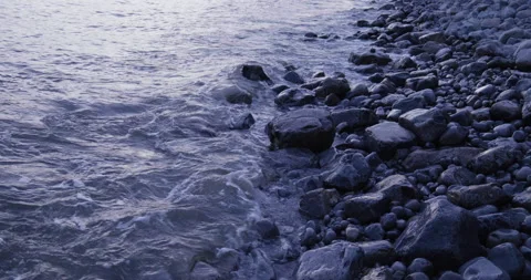 Low Angle Medium Shot of Water Breaking Over Rocks Stock Footage 205881948
