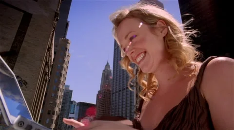 Low angle medium shot woman using laptop on roof / kissing and hugging computer Stock Footage 46258963