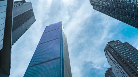 Low-Angle Modern Glass Skyscrapers Against Blue Sky in Urban Financial District Stock Footage 341995977