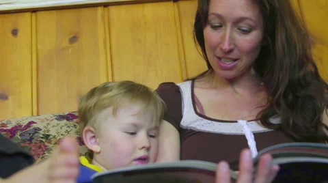 Low angle of mom reading to son Stock Footage 66257548
