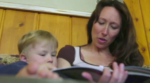 Low angle of mother reading to son Video stock 66257150