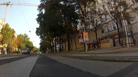Low angle in motion shot of the car driving on Vienna ring with cyclist Stock Footage 21452924