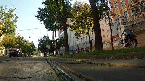 Low angle in motion shot of the car driving on Vienna ring with cyclist Stock Footage 21453220