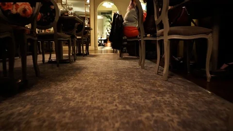 Low angle move forward through the dining room of a restaurant Stock Footage 106810582