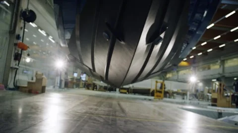 Low Angle Move Under Sharp Keel of Motorboat Hull, Modern Shipyard, Wide Shot Stock Footage 340329443