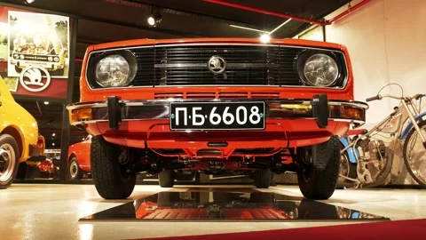 Low-Angle Moving Front Shot of Red Škoda 105 L at Retro Museum Varna Stock Footage 320896396