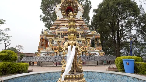 Low angle moving towards shot of multi headed buddha statue at temple in Nepal Video stock 91135947