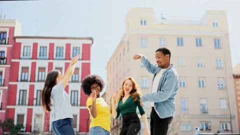 Low angle of a multiethnic group of friends dancing outdoors Stock Footage 236423861
