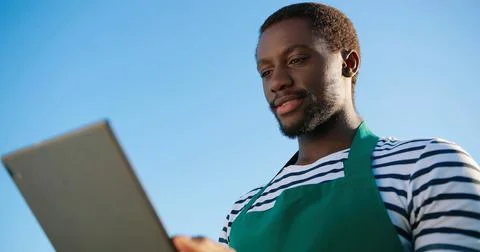 Low angle of the multiracial greenery worker checking impact of new technology Stock Photos