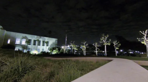 Low angle night time shot of building and skater figures 스톡 동영상 35817474