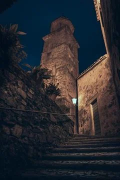 Low angle night view of historic bell tower and stone steps in Morcote 스톡 사진