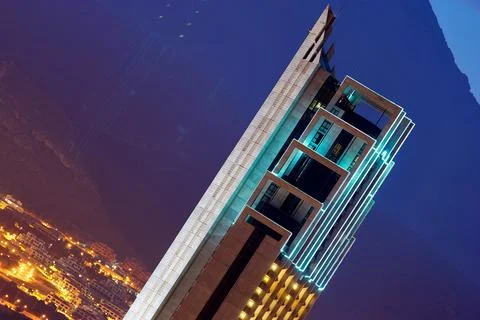 Low angle night view of the illuminated Gran Hotel Bali skyscraper with neon  Stock Photos