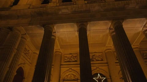 Low Angle Nighttime Shot of Saint-Sulpice Facade Lit by Warm Golden Lights Stock Footage 319003057