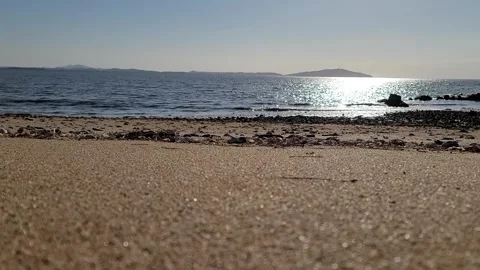 Low Angle Ocean Waves with Sunlight Reflection on Sandy Beach, 4K Vídeos de archivo 330035498