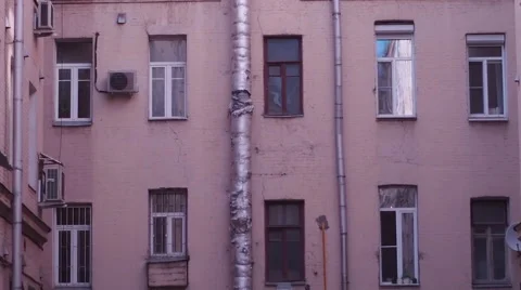 Low Angle of an Old Wall With a Downspout and Dirty Windows After a Fire in Stock Footage 66188579