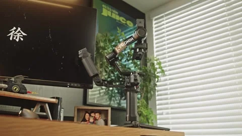 Low Angle Orbit Shot of DJI RS 5 in front of black Computer Screen in Bright Stock Footage 332035506