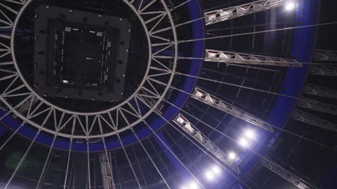 Low angle orbital under enormous event Stadium roof framework structure Stock Footage 300993612