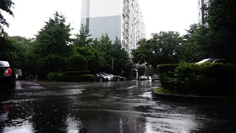 Low-Angle Overcast Shot of Moderate Rain in Apartment Car Park, HD Stock Footage 202299252