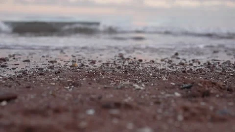 Low Angle of Paignton Preston Beach of Waves Lapping Red sand and Pebbles Vídeo Stock 224735480