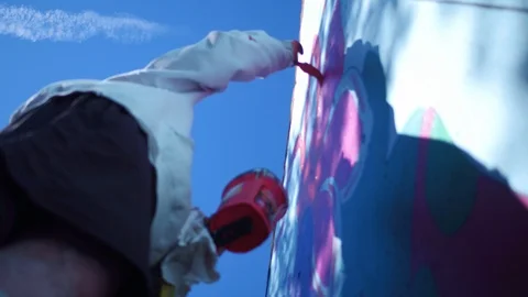 LOW ANGLE PAINT RED MURAL FROM LADDER Stock-Footage 111710857