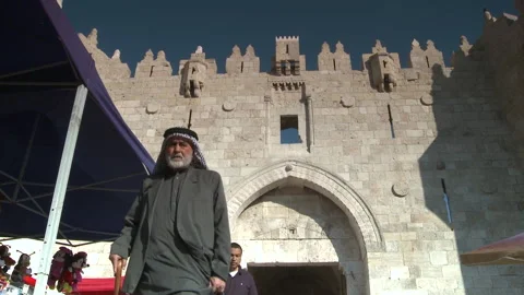 Low Angle Palestinian Arab Men Walking By From The Damascus Gates Of Jerusalem Stock Footage 238664383