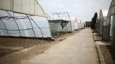 Low angle Pan and tilt shoot of hothouses Stock Footage 60765979