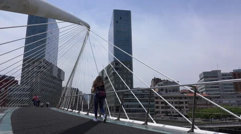 Low angle pan of people crossing the Zubizuri bridge Stock Footage 64300027