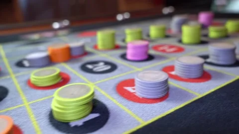 Low angle pan roulette table with chips casino scene Video stock 332511364
