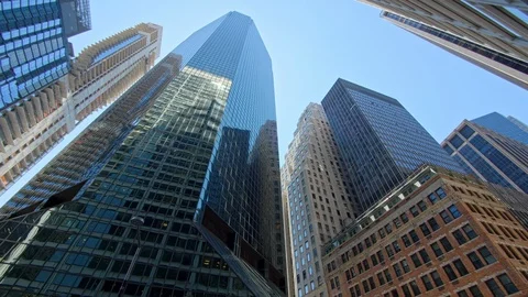 Low angle panning New York City corporate skyscrapers reflecting glass facades Stock Footage 122304427