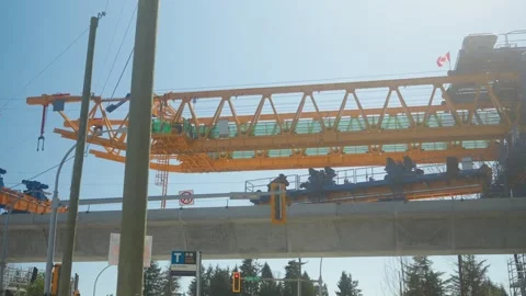Low angle panning shot revealing yellow launching gantry constructing Surrey Stock Footage 333645186