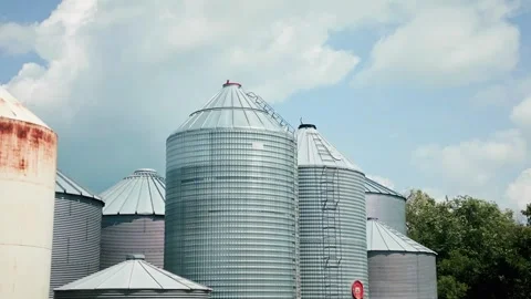 Low Angle Parallax Drone Shot of Grain Silos Against Blue Sky Stock-Footage 342012859