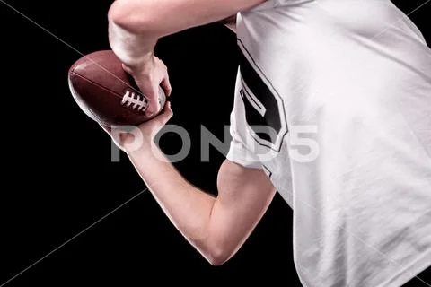 Low angle partial view of man in white t-shirt holding rugby ball Stock Photos