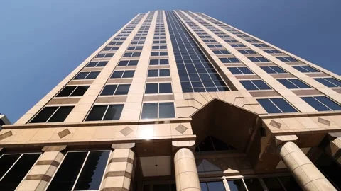 Low Angle Pass By Tall Skyscraper On Clear Sunny Day Slow Motion  Stock-Footage 233457451