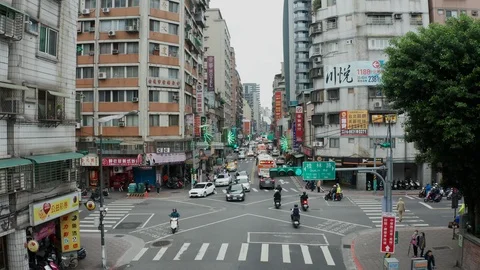 Low angle of people and traffic crossing busy intersection in Taipei Stock Footage 104770634
