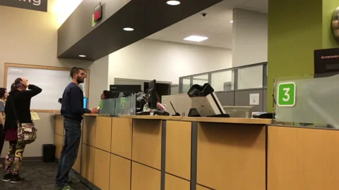 Low angle of people applying driver license at reception site inside ICBC 스톡 동영상 90364473