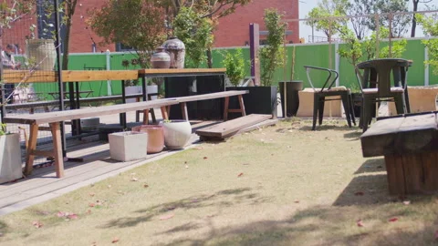Low angle of person behind screen in sunlit outdoor patio dining area Stockbeeldmateriaal 332852260