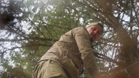 Low Angle of Person Digging Grave in a Forest Stock Footage 308864169