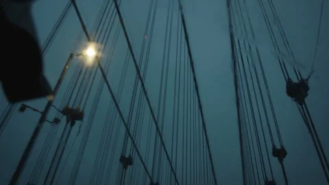 Low angle perspective crossing brooklyn bridge toward queens on a dreary evening Vídeos de archivo 251227332