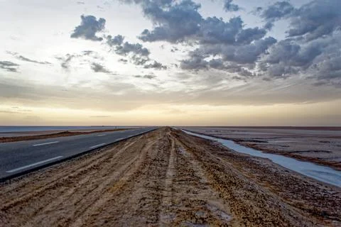 Low Angle Perspective of Empty Straight Highway Stretching Across Flat Salt.. Stock Photos