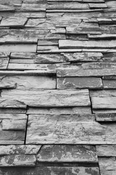 Low Angle Perspective of High Stone Blocked Wall in Monochrome Stock Photos
