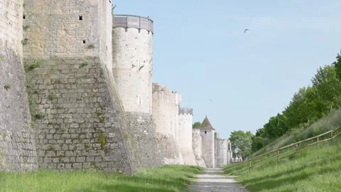 Low-angle perspective looking up at a massive historic stone fortress wall again Stock Footage 336133608