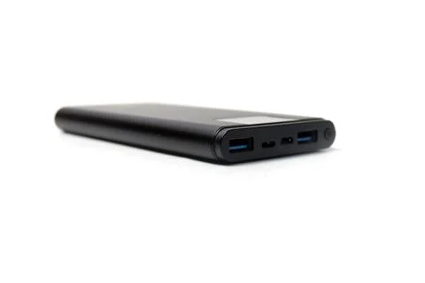 Low-angle perspective shot of a modern black portable power bank isolated o.. Fotos de archivo