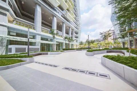 Low angle perspective view of empty pavement and modern office building with  Stock Photos