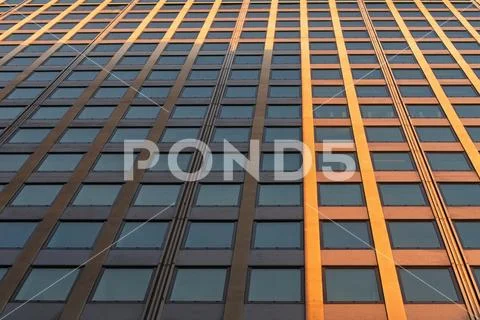 Low angle perspective view of mordern building's exterior with glass windows. Stock Photos