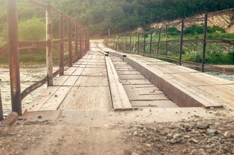 Low Angle Perspective View of the Old Bridge over the Mountain River Stock Photos
