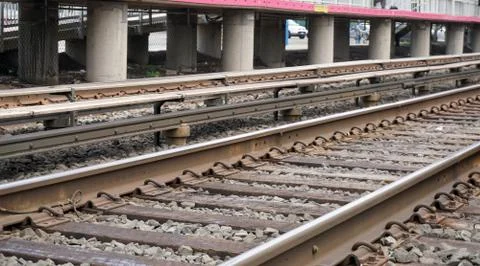 Low angle photo of the third rail. Electrified high voltage power source Stock Photos