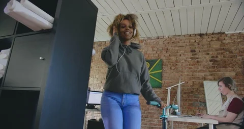 Low angle portrait of beautiful african american woman that listens to music in Stock Footage 112534094